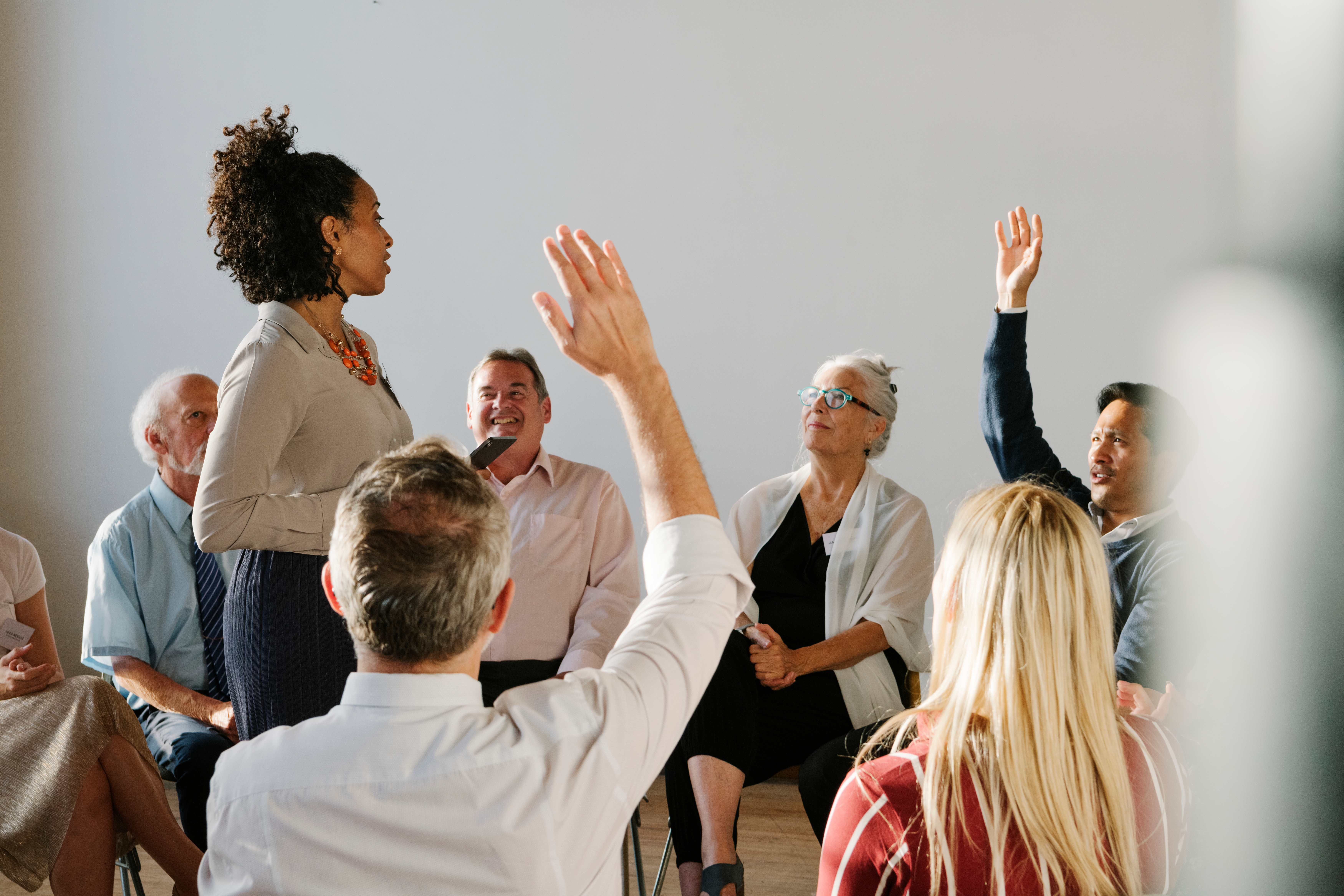 Diverse community members engaged in supportive group discussion